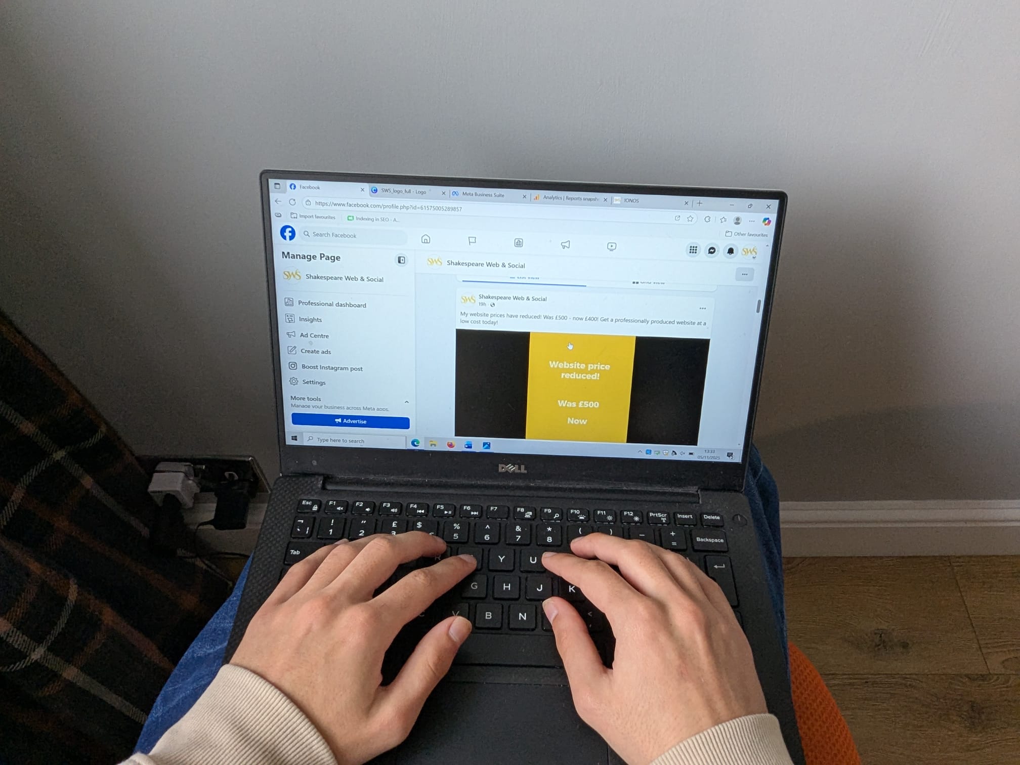 Person's hands on a computer editing the Facebook page of Shakespeare Web & Social